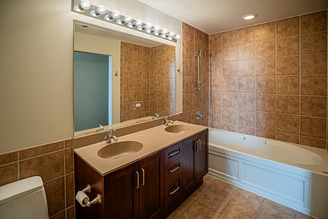 bathroom with tile patterned floors, vanity, toilet, and tile walls