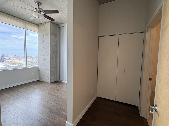 hall with wood finished floors and baseboards