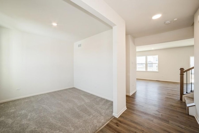 spare room with dark hardwood / wood-style flooring