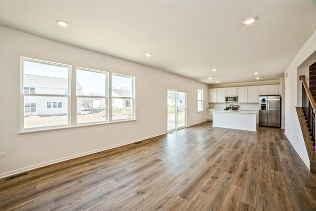 unfurnished living room featuring light hardwood / wood-style floors