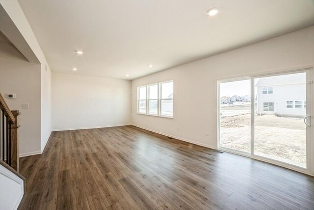 unfurnished living room featuring dark hardwood / wood-style flooring