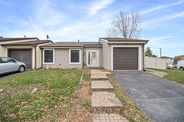 ranch-style house with a garage and a front lawn