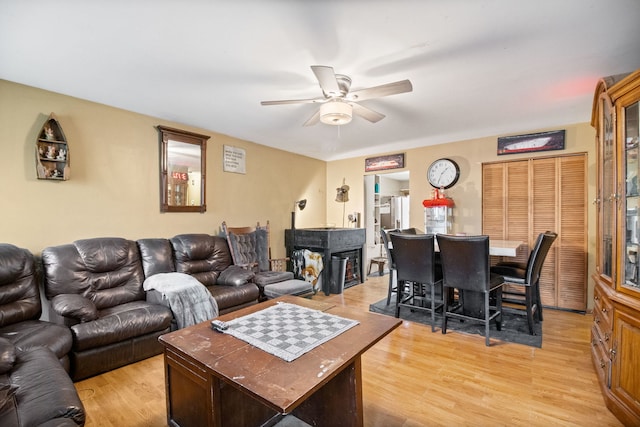 living room featuring ceiling fan and light wood-type flooring