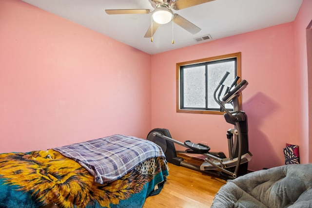 bedroom with hardwood / wood-style floors and ceiling fan