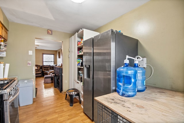 kitchen with stainless steel appliances and light hardwood / wood-style floors