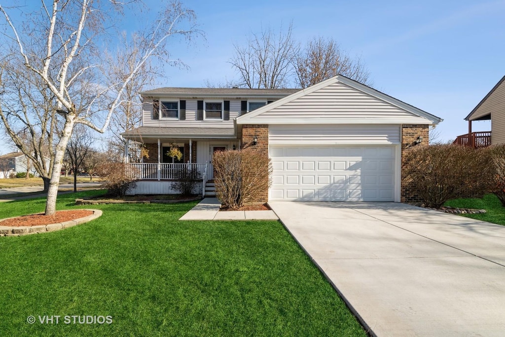 front of property featuring a porch, a garage, and a front yard