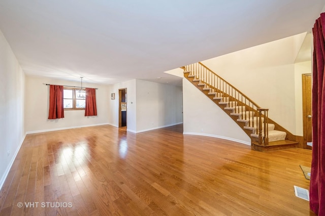 unfurnished living room with hardwood / wood-style flooring