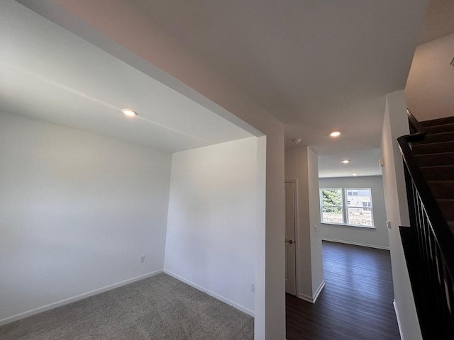 unfurnished room featuring baseboards, recessed lighting, and stairway
