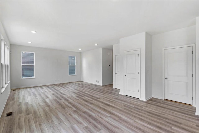 unfurnished room with light wood-type flooring