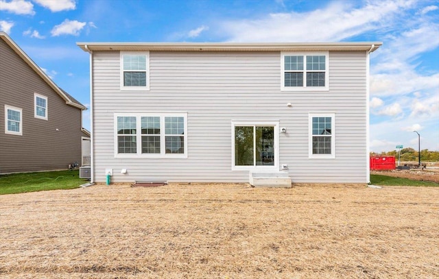 rear view of property featuring central AC