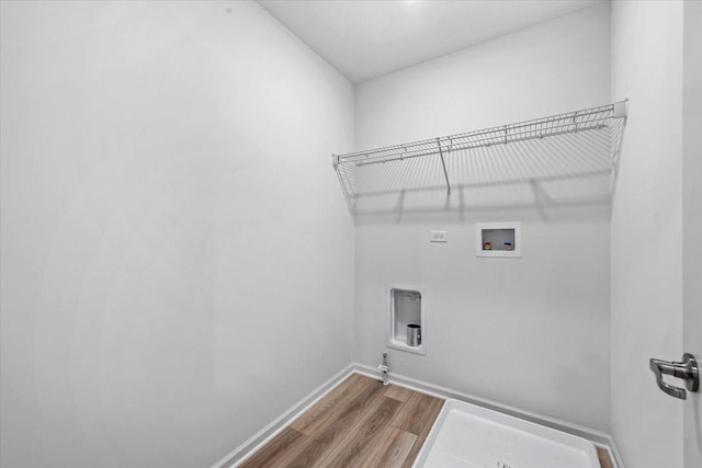 washroom featuring washer hookup, hookup for an electric dryer, gas dryer hookup, and hardwood / wood-style floors