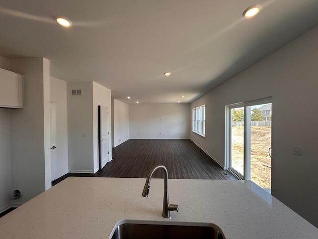 kitchen with recessed lighting, visible vents, a sink, and light stone counters