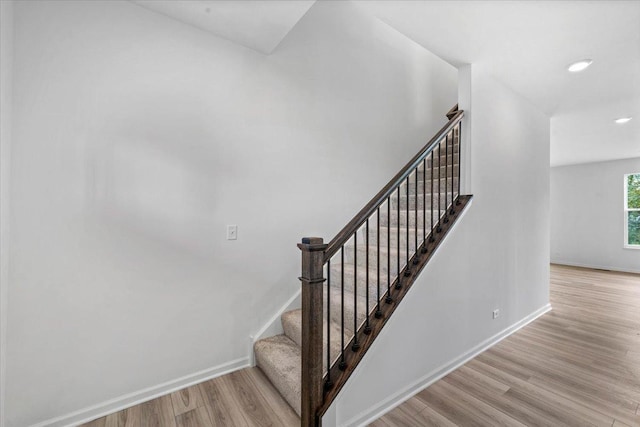 stairs with hardwood / wood-style flooring