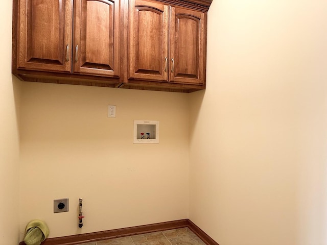 washroom featuring electric dryer hookup, hookup for a gas dryer, hookup for a washing machine, and cabinets