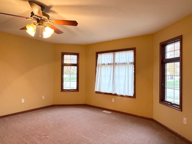 empty room with carpet flooring and ceiling fan