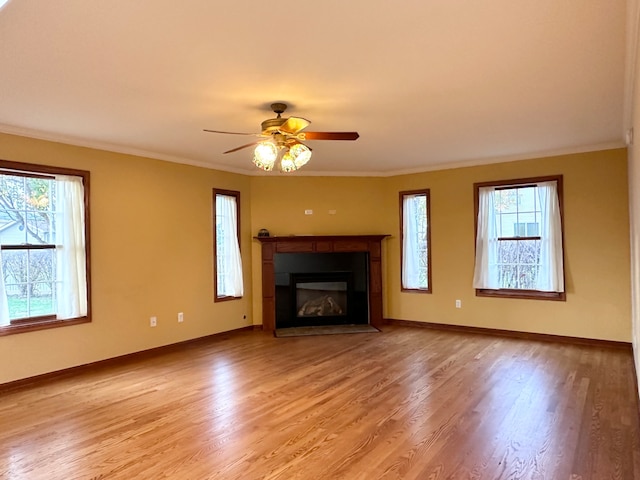 unfurnished living room with ceiling fan, light wood-type flooring, and ornamental molding