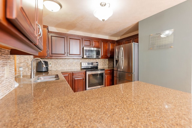 kitchen featuring backsplash, stainless steel appliances, and sink