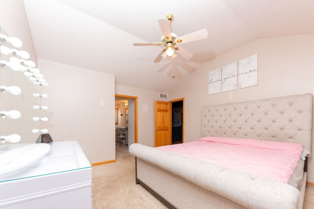 carpeted bedroom with vaulted ceiling and ceiling fan