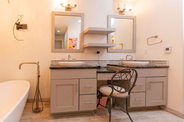 bathroom featuring vanity and a bath