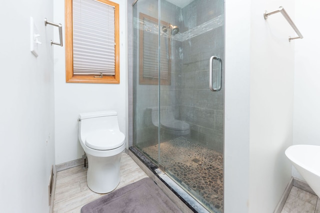 bathroom with toilet and an enclosed shower