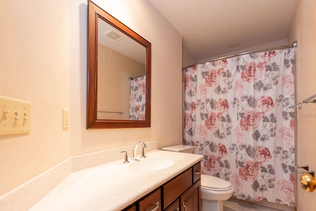 bathroom with vanity, a shower with shower curtain, and toilet