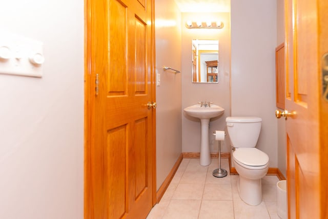 bathroom with tile patterned floors, toilet, and sink