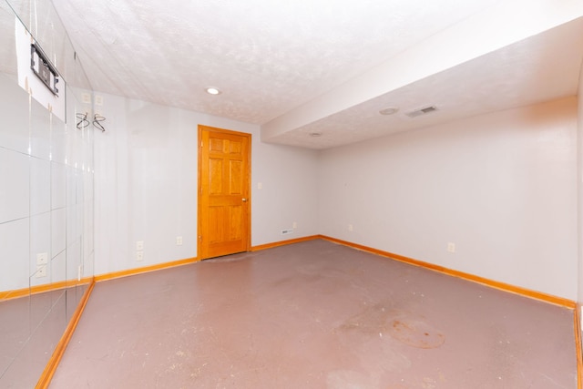 basement featuring a textured ceiling