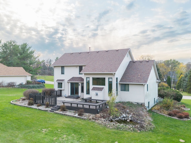 back of property featuring a yard and a deck