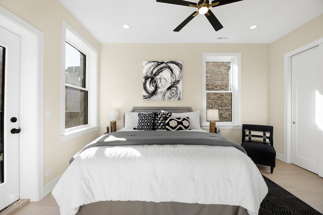 bedroom featuring ceiling fan, light wood-style flooring, recessed lighting, visible vents, and baseboards