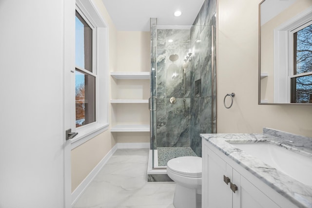 bathroom featuring a stall shower, baseboards, toilet, marble finish floor, and vanity