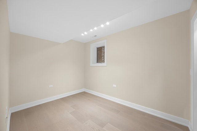 empty room with light hardwood / wood-style flooring