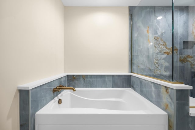 bathroom with a garden tub
