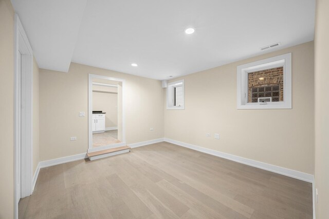 kitchen with light hardwood / wood-style floors, sink, dark brown cabinets, and wine cooler