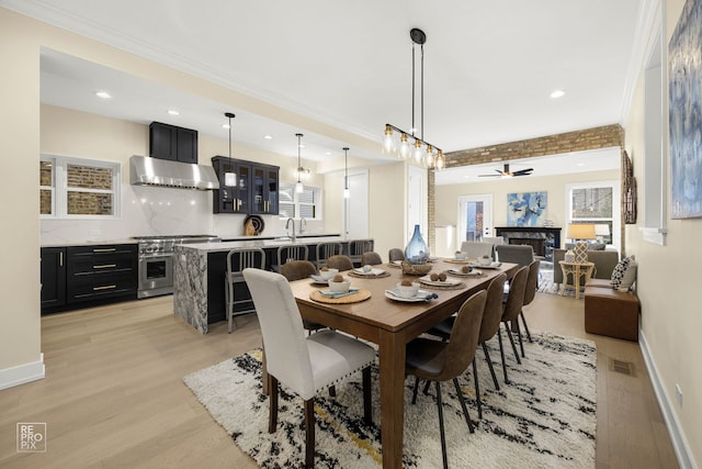 dining space featuring light wood finished floors, baseboards, and visible vents