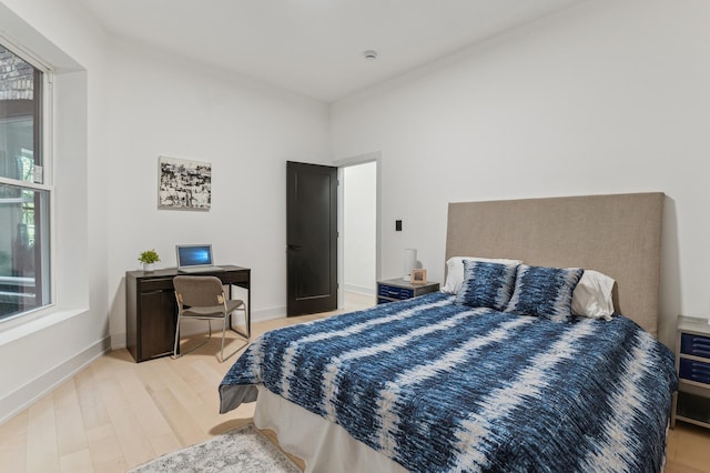 bedroom featuring multiple windows and hardwood / wood-style floors