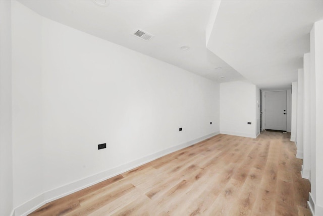 additional living space with light hardwood / wood-style flooring