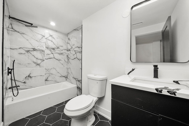 full bathroom featuring tile patterned floors, tiled shower / bath combo, toilet, and vanity