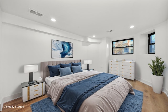 bedroom with hardwood / wood-style floors