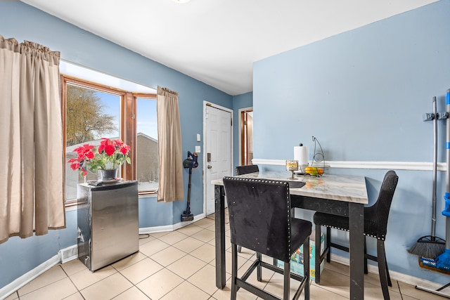 dining area with light tile patterned floors