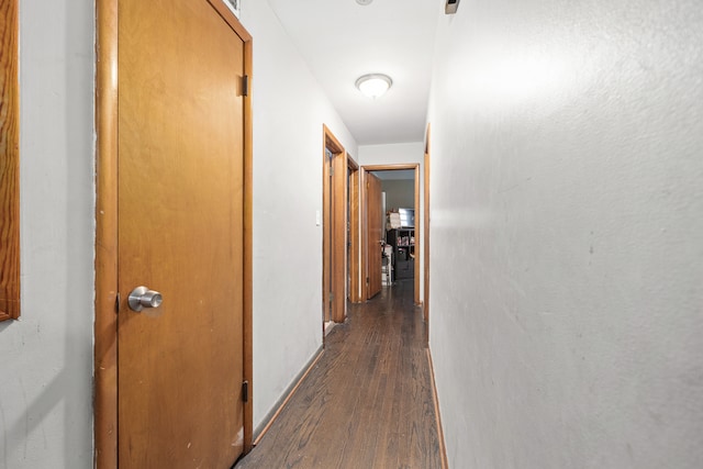 corridor featuring dark wood-type flooring