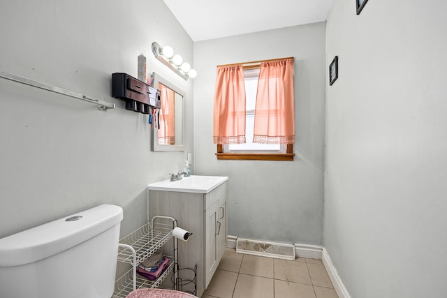 bathroom with tile patterned flooring, vanity, and toilet