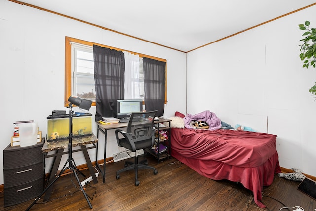 bedroom with crown molding and dark hardwood / wood-style flooring