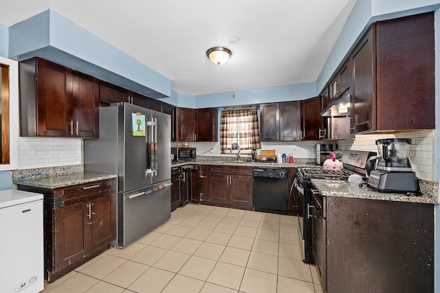 kitchen featuring decorative backsplash, sink, light stone counters, and black appliances