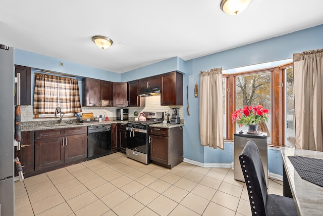 kitchen with sink, tasteful backsplash, light stone counters, dark brown cabinetry, and stainless steel appliances