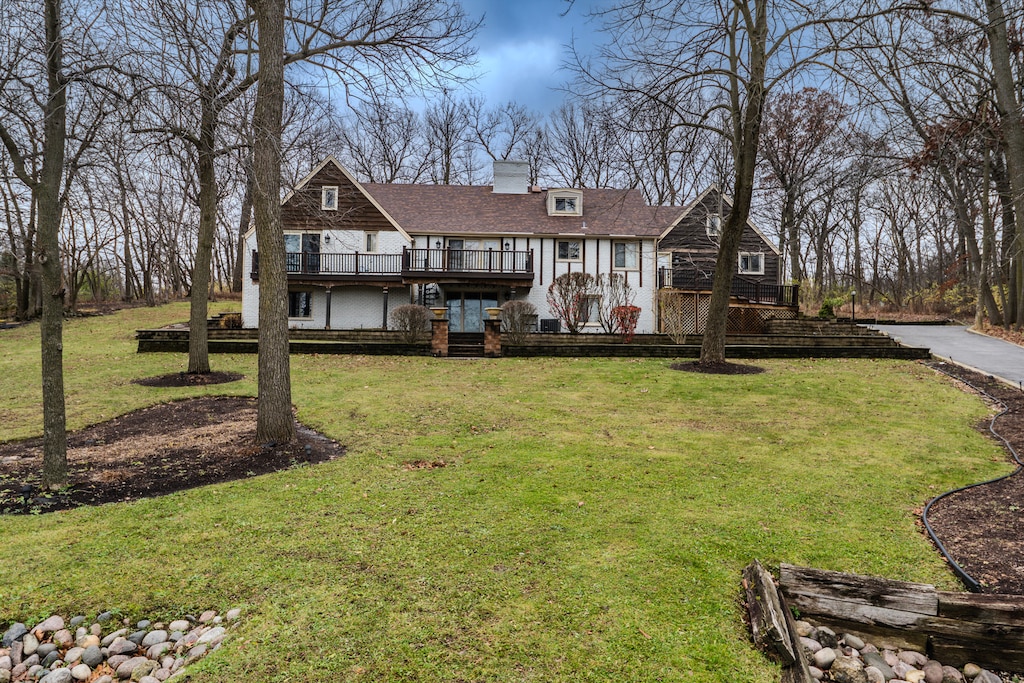 view of front of property with a front lawn and a deck