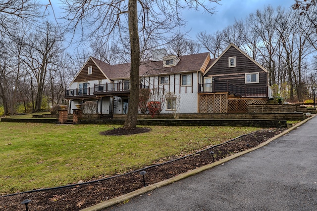 view of front of house featuring a deck and a front lawn