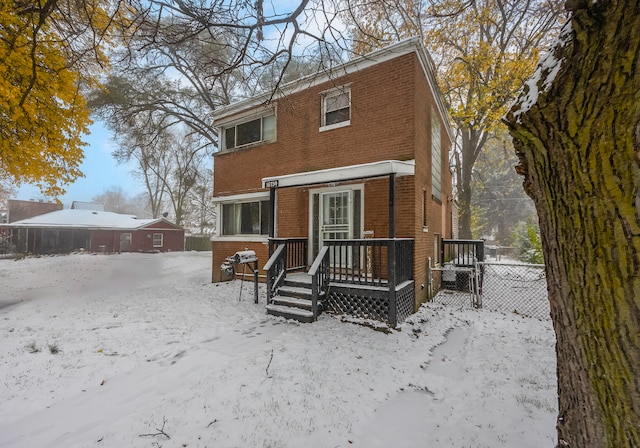 view of snow covered back of property