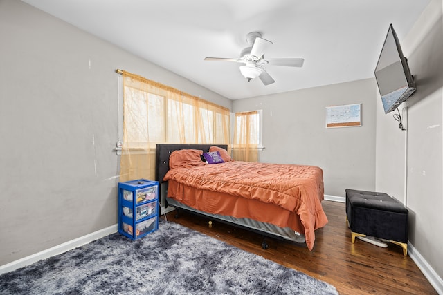 bedroom with dark hardwood / wood-style floors and ceiling fan