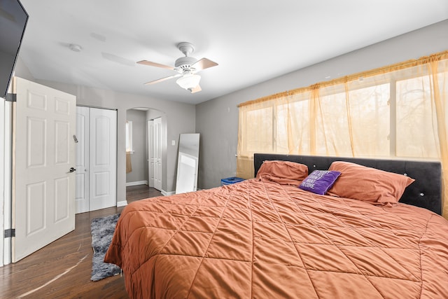 bedroom featuring dark hardwood / wood-style flooring, a closet, and ceiling fan