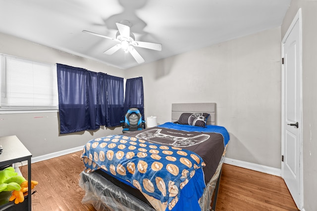 bedroom with ceiling fan and hardwood / wood-style floors